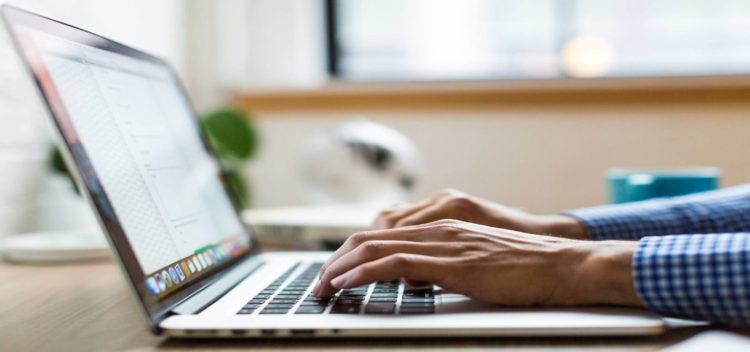 typing at laptop